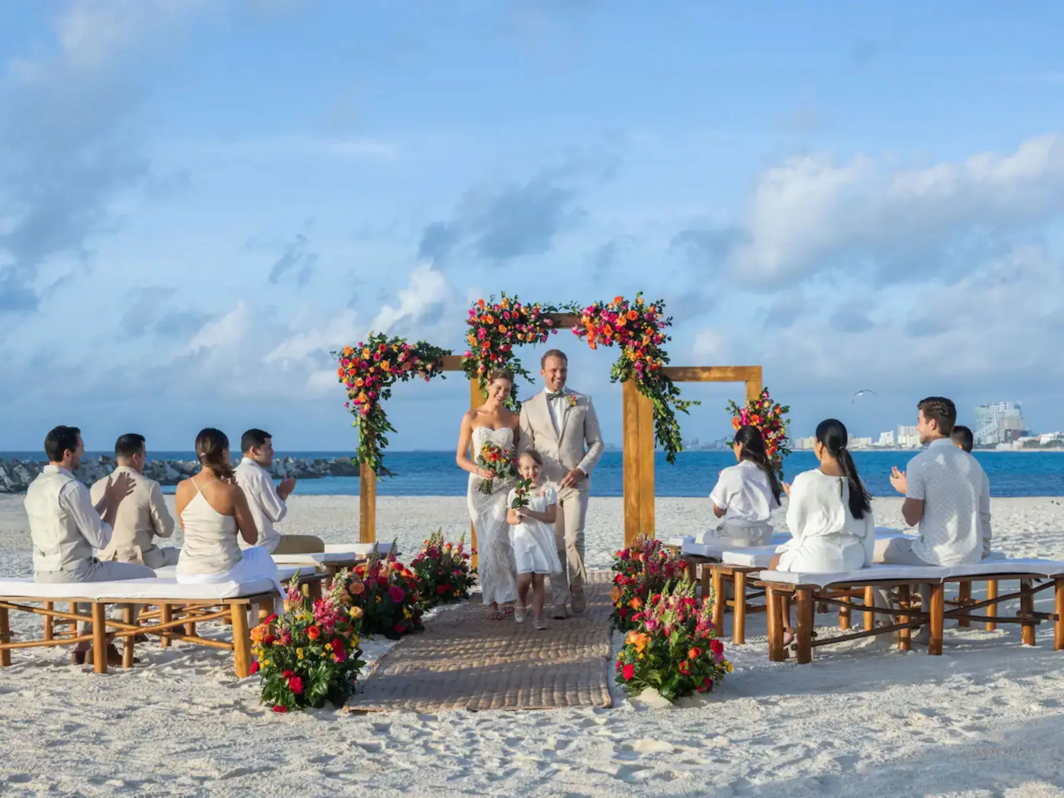 bride and groom and their child and guests at Hyatt Ziva Cancun Sahara beach venue