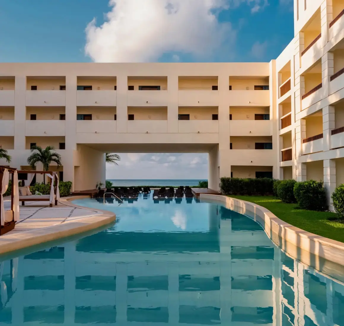 main pool with poolside loungers and the resort accommodations at Hyatt Ziva Riviera Maya