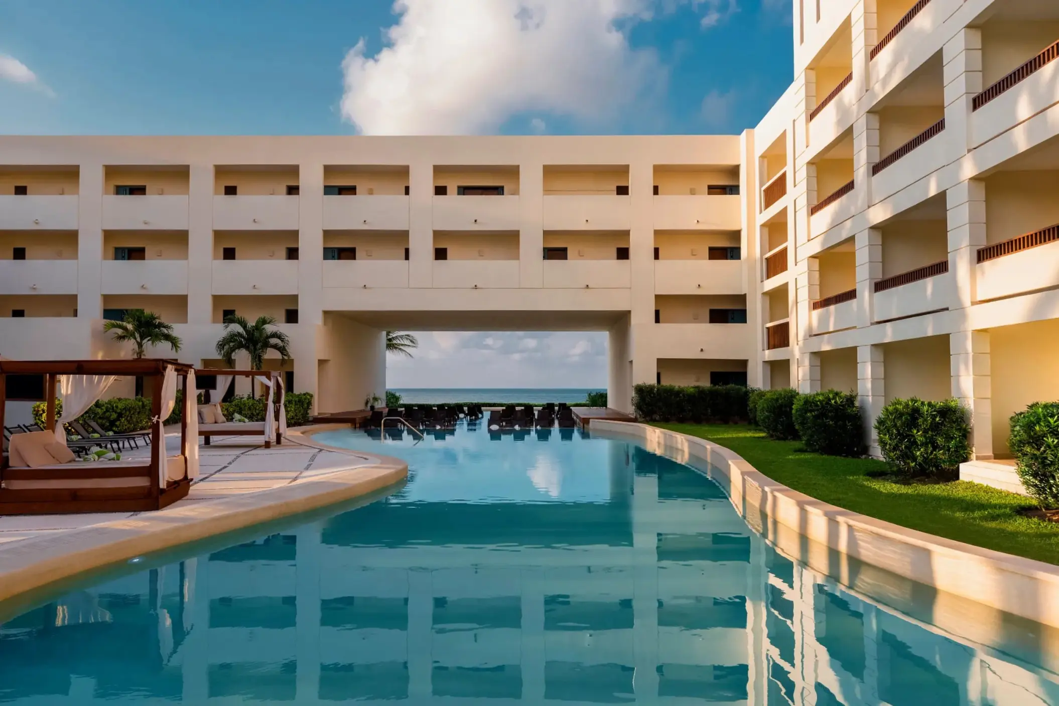 main pool with poolside loungers and the resort accommodations at Hyatt Ziva Riviera Maya
