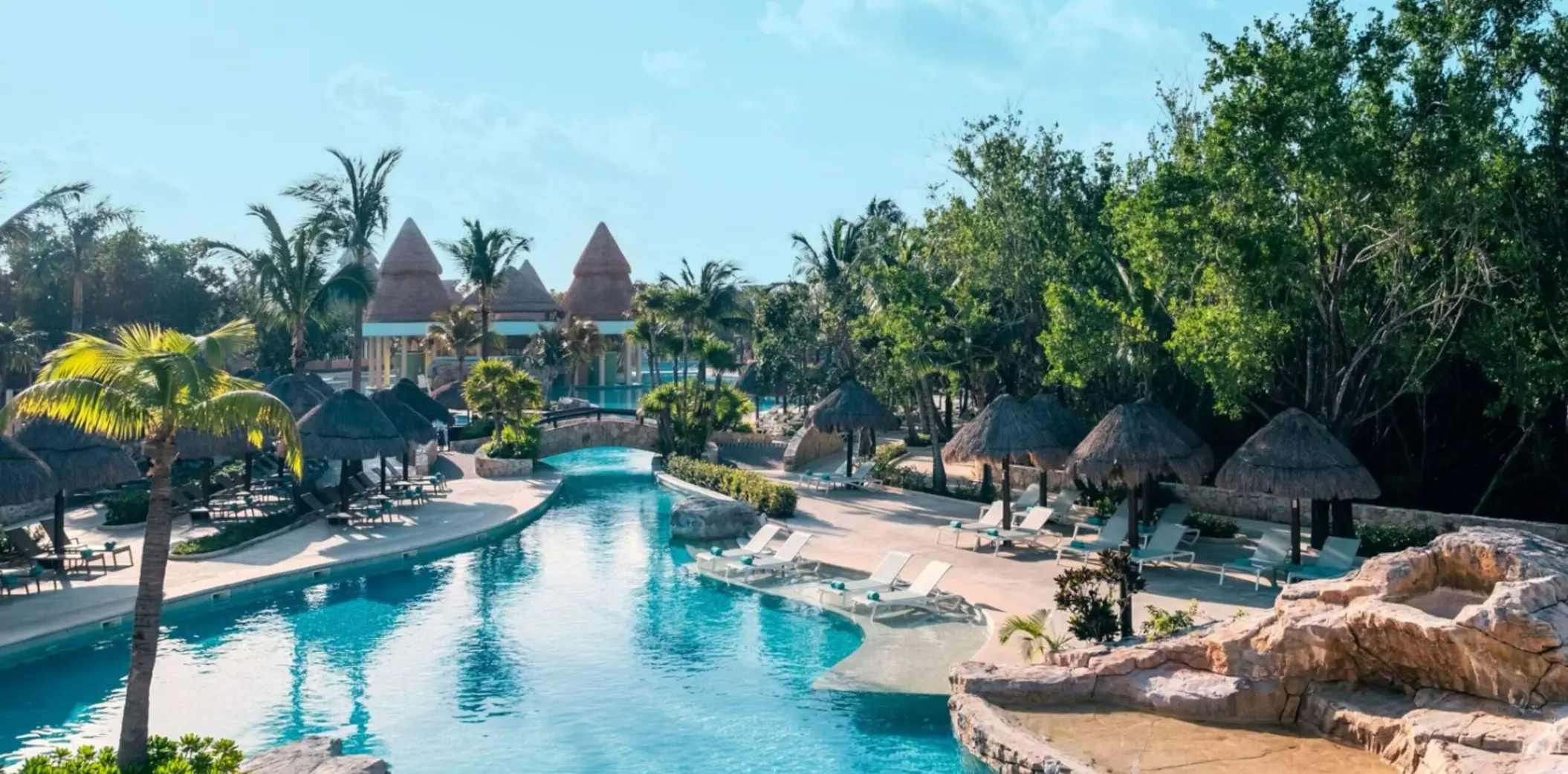 pool and loungers with swim up bar in the background at Iberostar Selection Paraiso Maya Suites