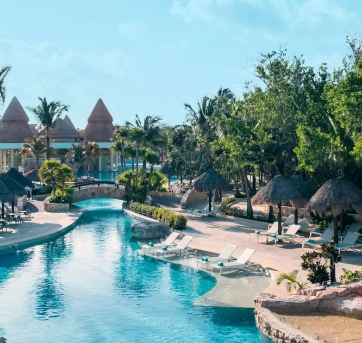 pool and loungers with swim up bar in the background at Iberostar Selection Paraiso Maya Suites