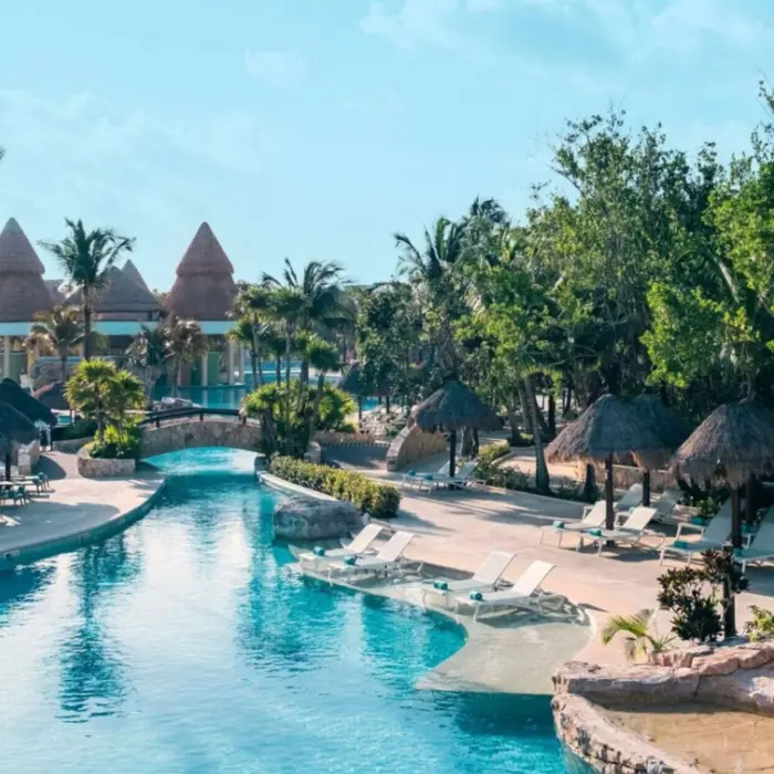 pool and loungers with swim up bar in the background at Iberostar Selection Paraiso Maya Suites