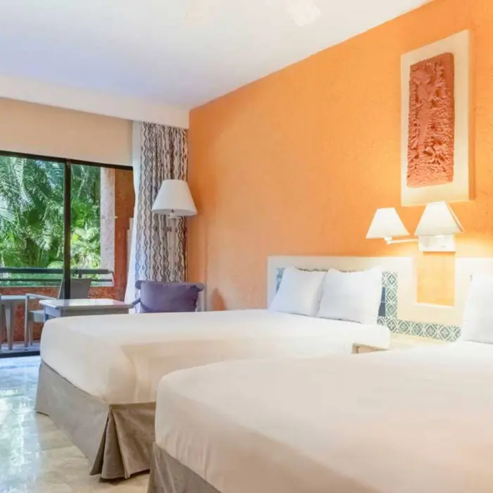 suite with two beds at Iberostar Waves Tucan