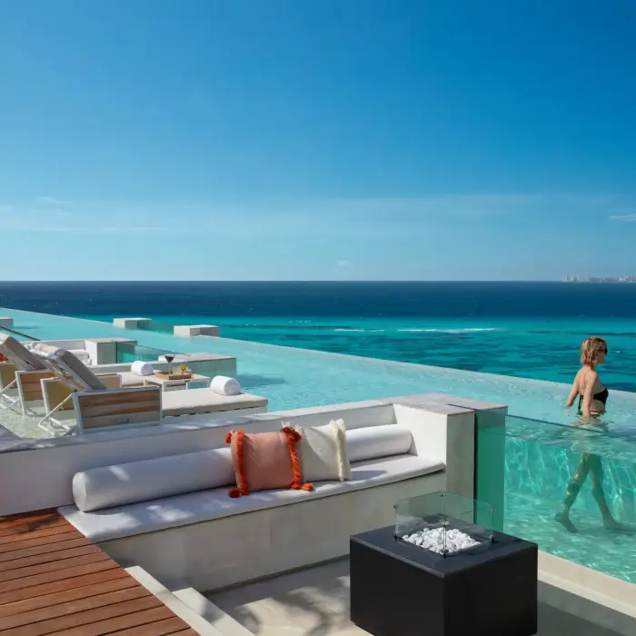 couple in the rooftop pool at Impression Isla Mujeres by Secrets