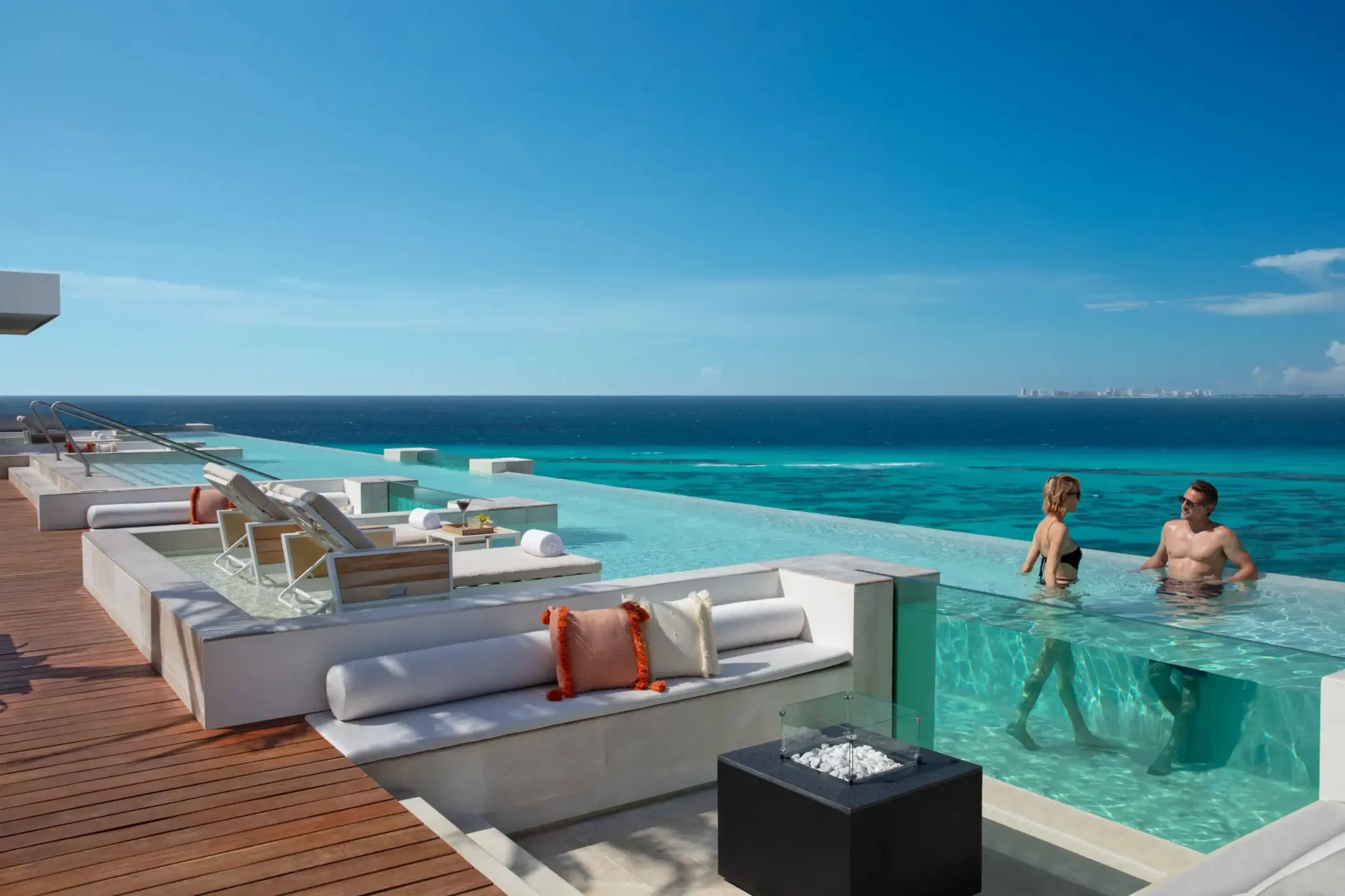 couple in the rooftop pool at Impression Isla Mujeres by Secrets