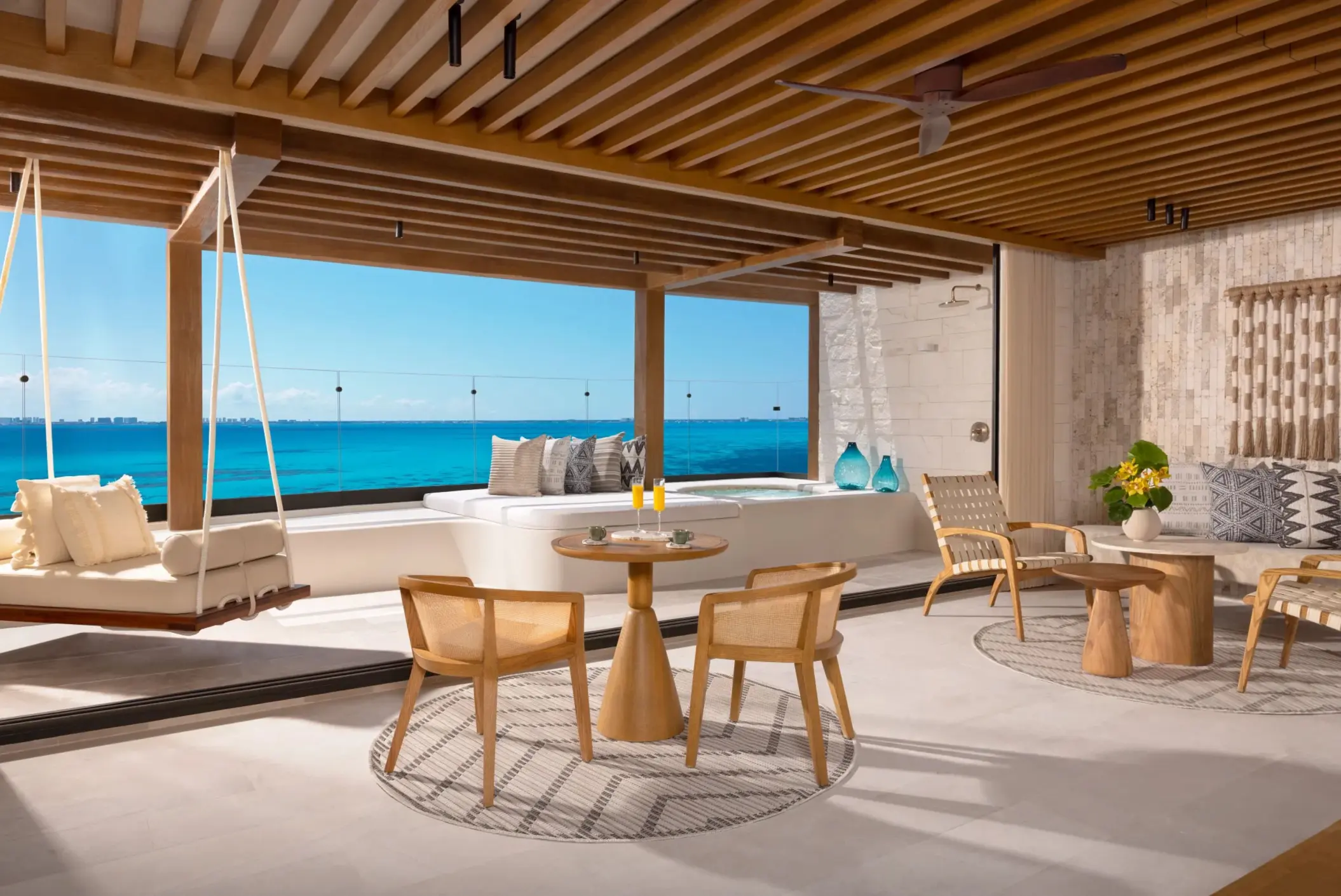 living area and balcony of a suite at Impression Isla Mujeres by Secrets