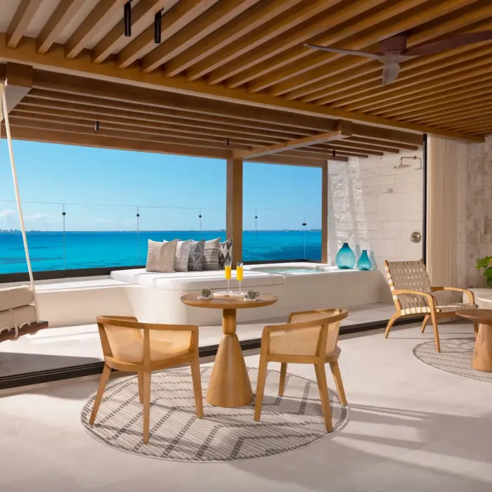 living area and balcony of a suite at Impression Isla Mujeres by Secrets