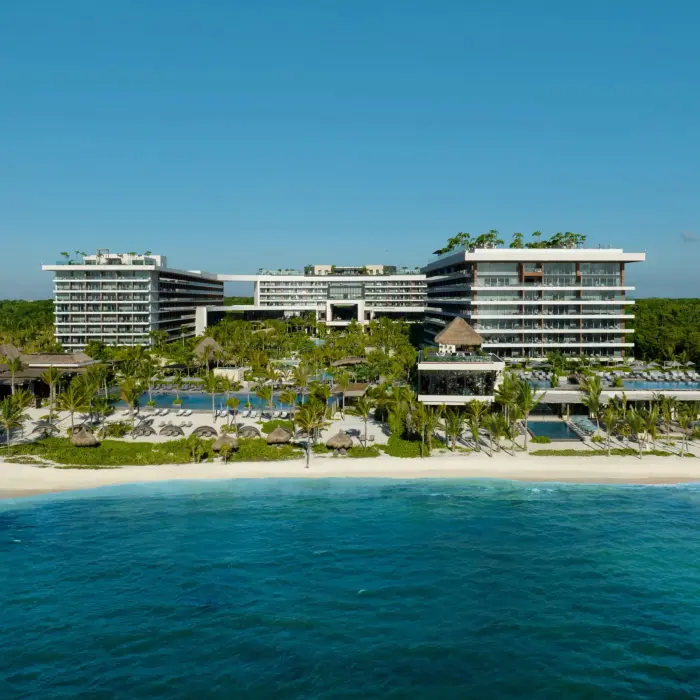 Aerial view of Secrets Impressions Moxché with lush gardens and beachside pools.