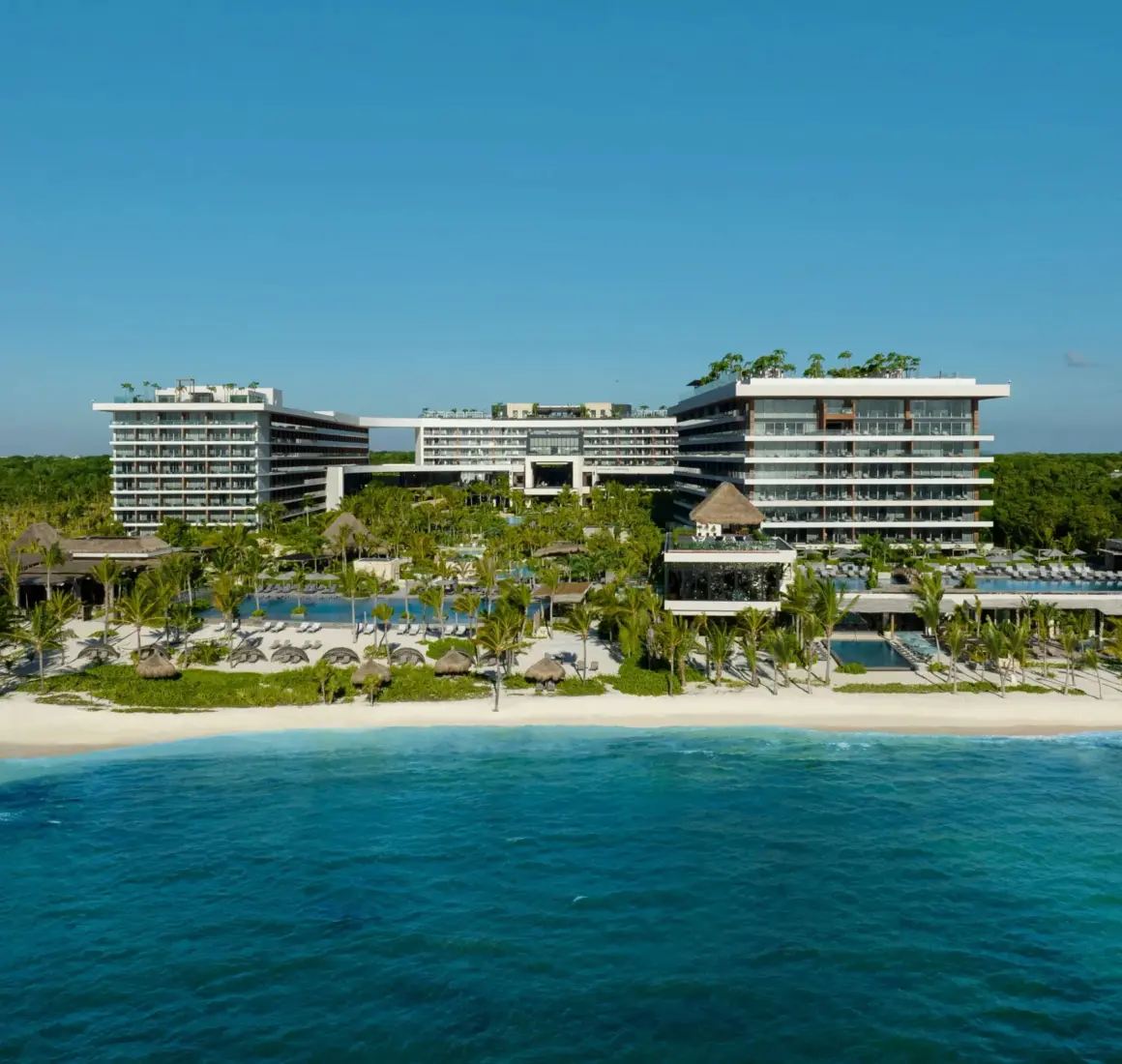 Aerial view of Secrets Impressions Moxché with lush gardens and beachside pools.