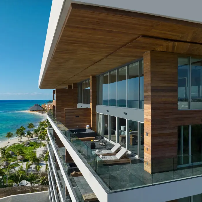 Spacious penthouse balcony with lounge chairs and ocean views at Secrets Impressions Moxché.