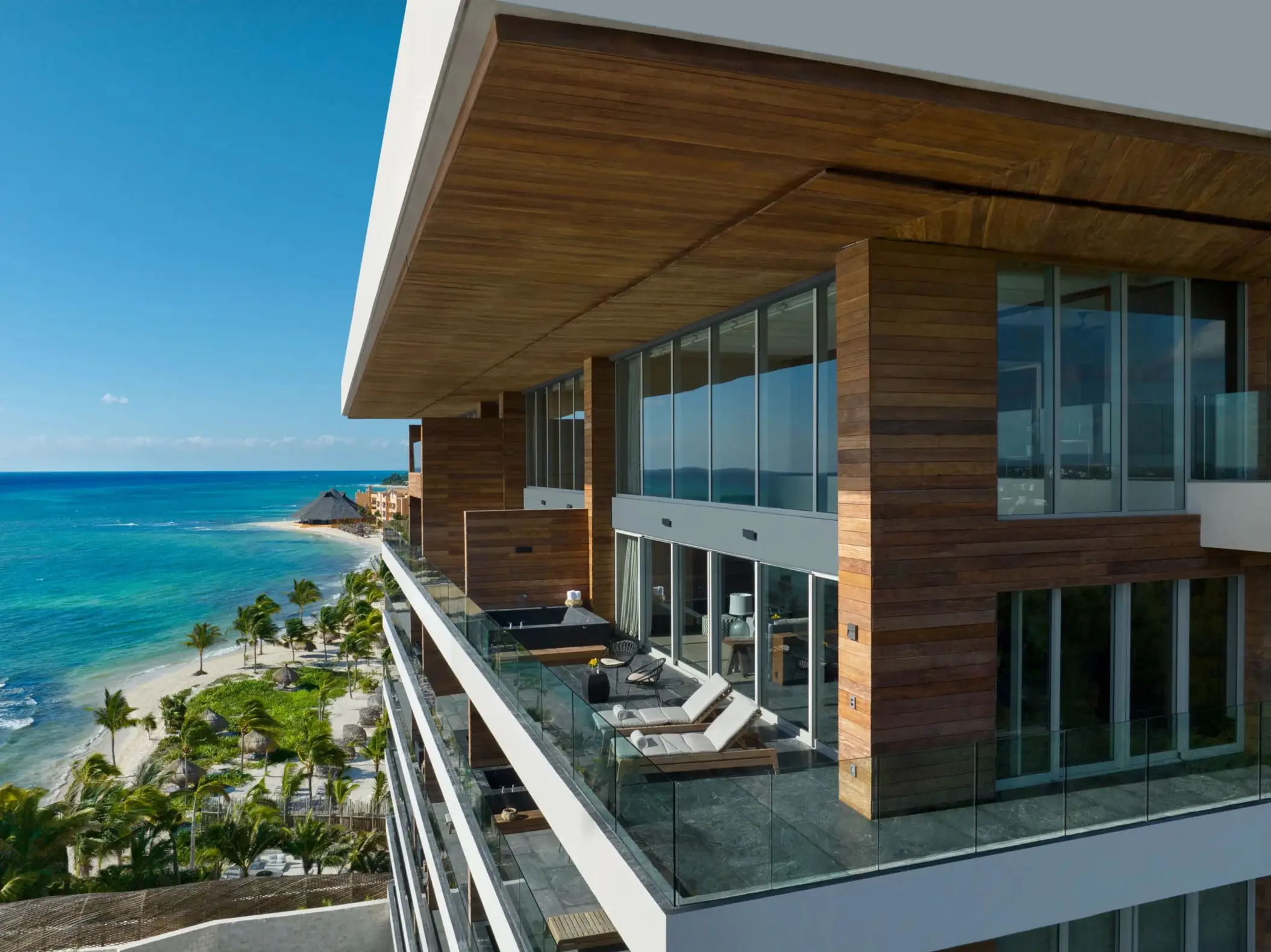 Spacious penthouse balcony with lounge chairs and ocean views at Secrets Impressions Moxché.