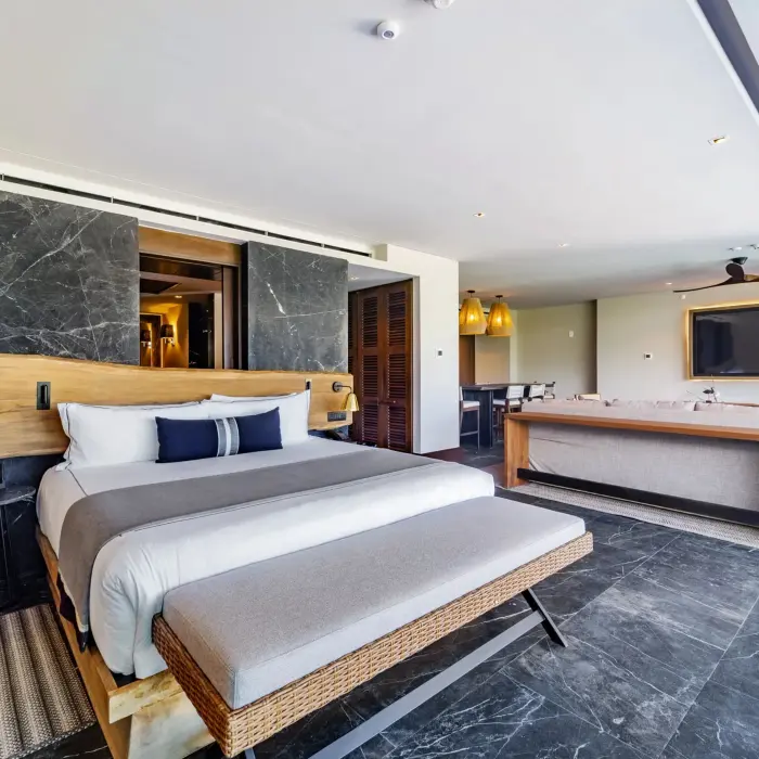 Tropical-inspired bedroom with neutral tones and modern comfort touches.