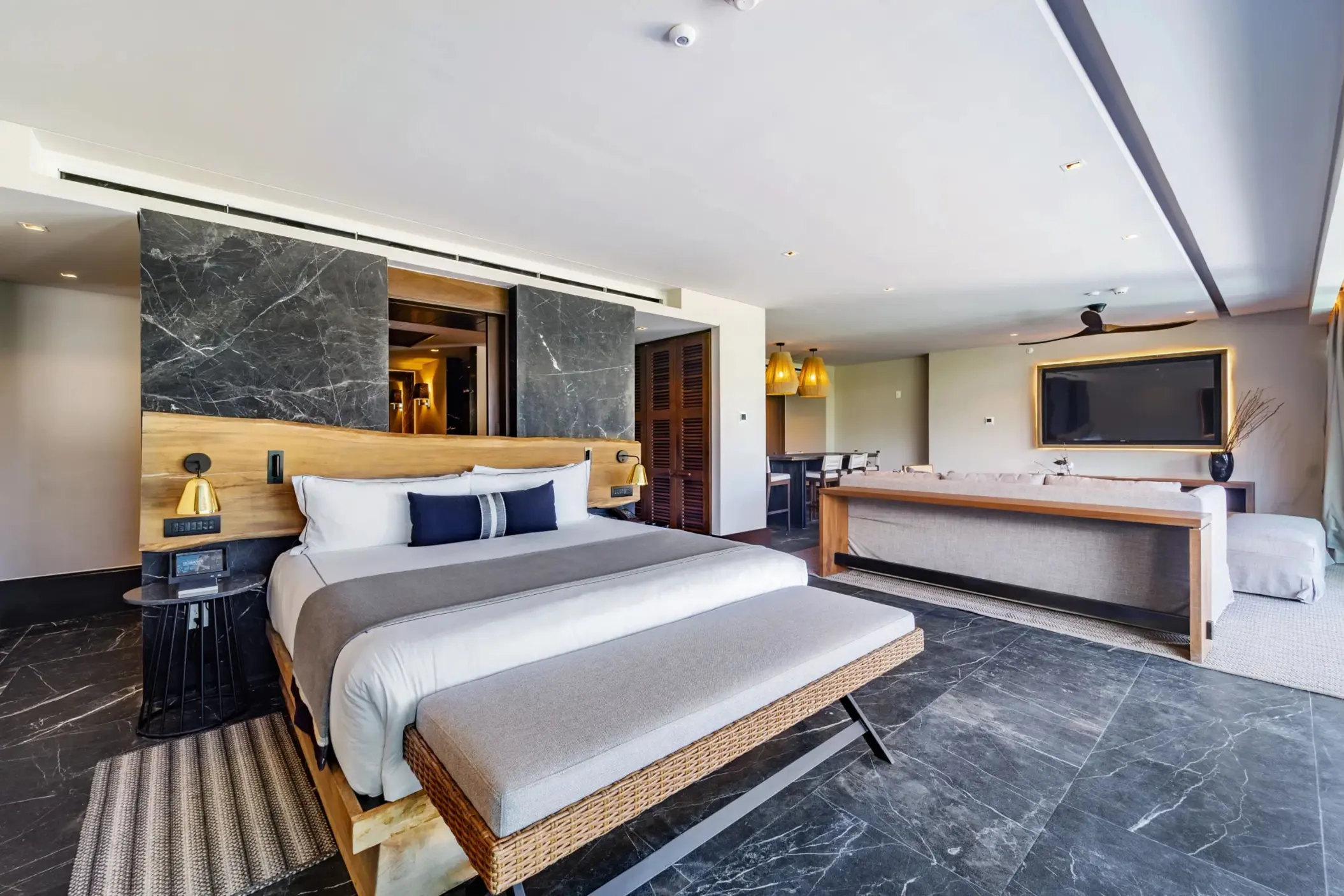 Tropical-inspired bedroom with neutral tones and modern comfort touches.