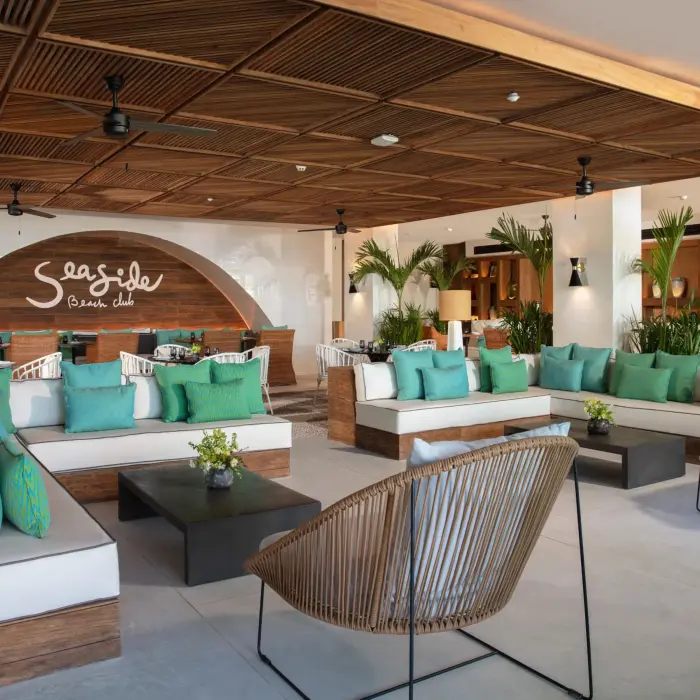 Colorful lounge area at Seaside Beach Club with plush seating and tropical décor.