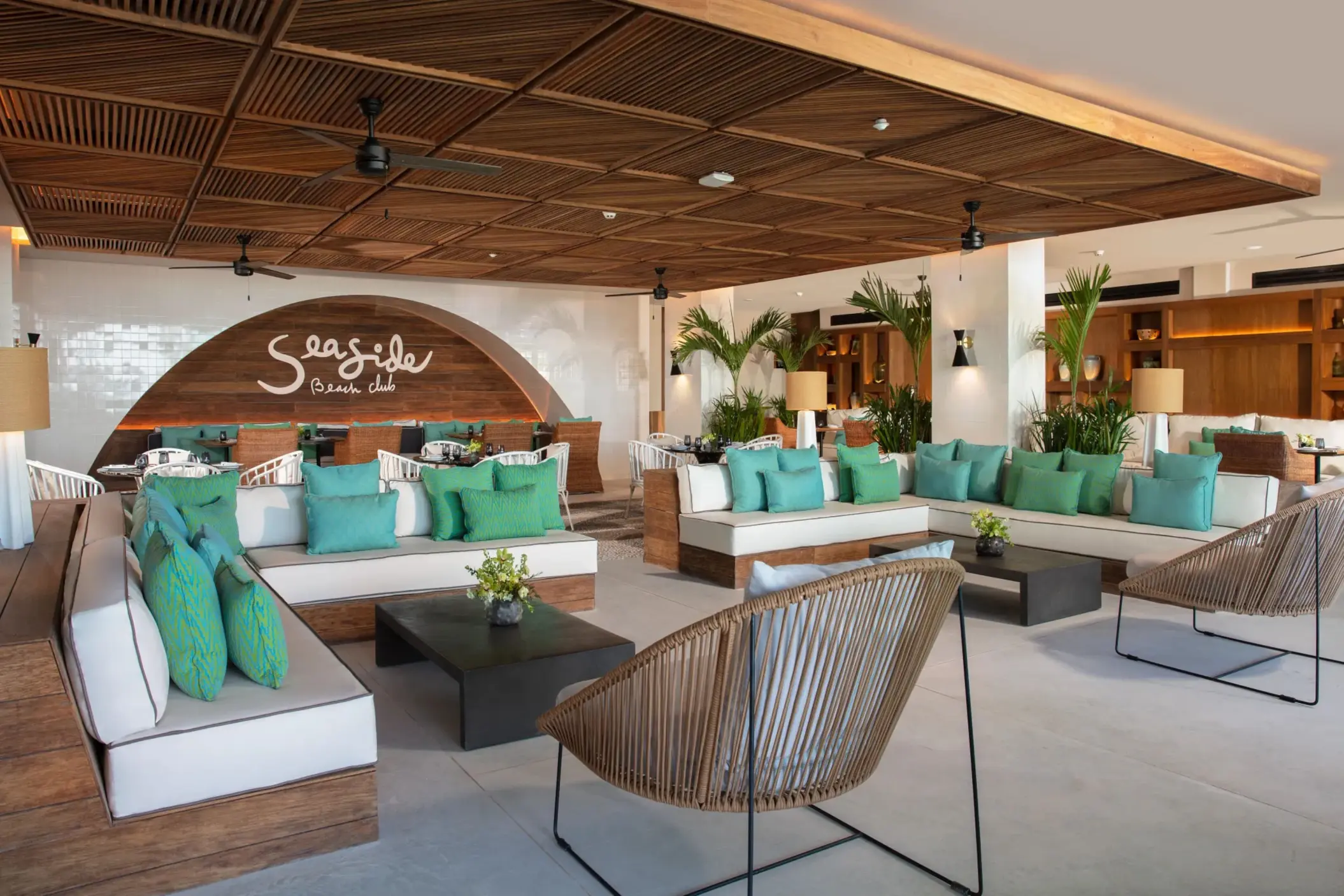 Colorful lounge area at Seaside Beach Club with plush seating and tropical décor.