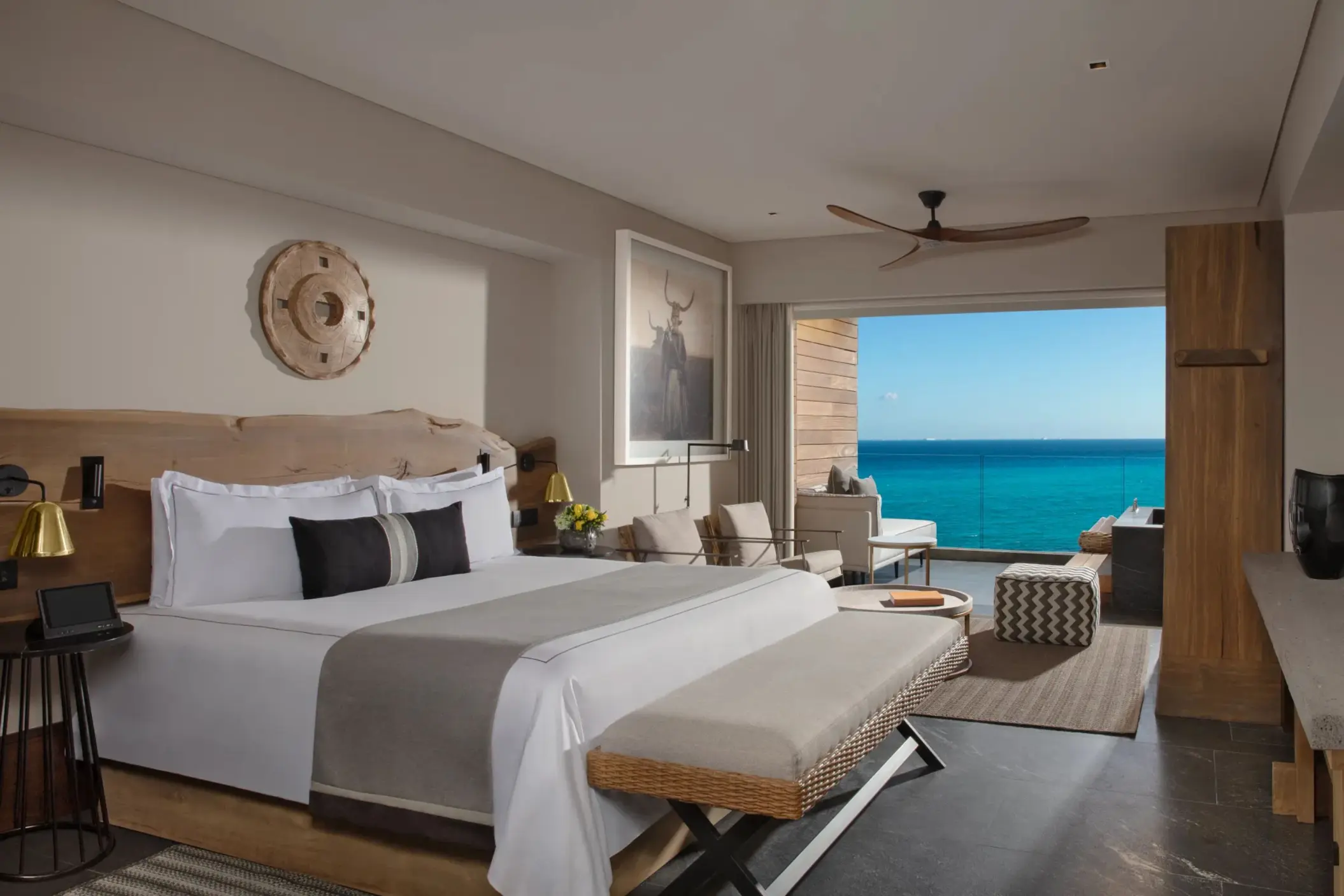 Oceanfront suite with king bed, lounge space, and stunning sea views.