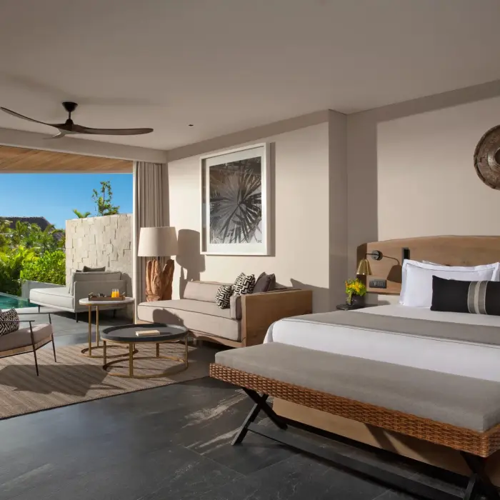 Signature Swim-Out Suite with stylish decor, direct pool access, and garden views at Secrets Impression Moxché.