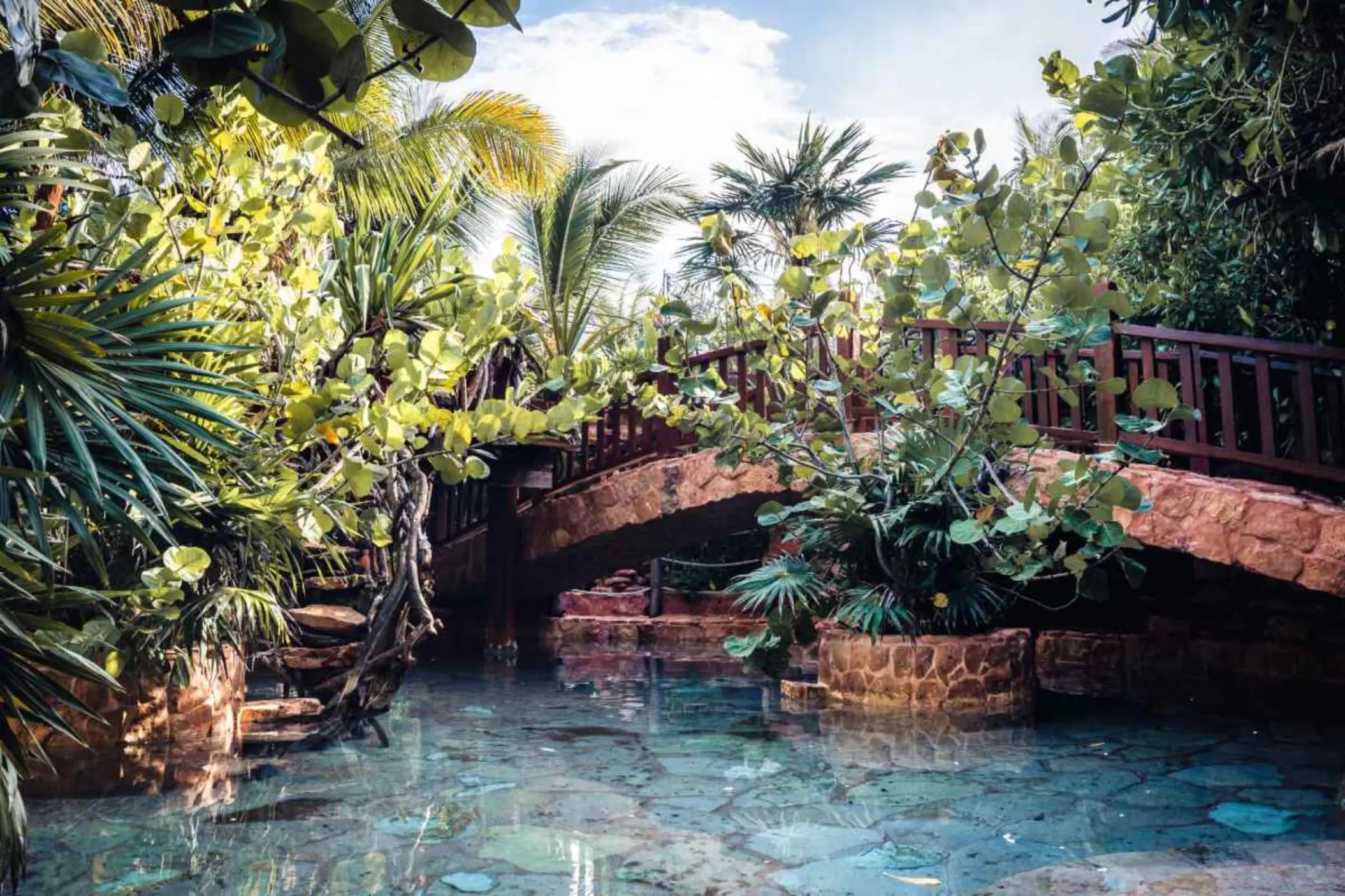 shallow water feature with bridge over it at Kanan Tulum Hotel & Spa