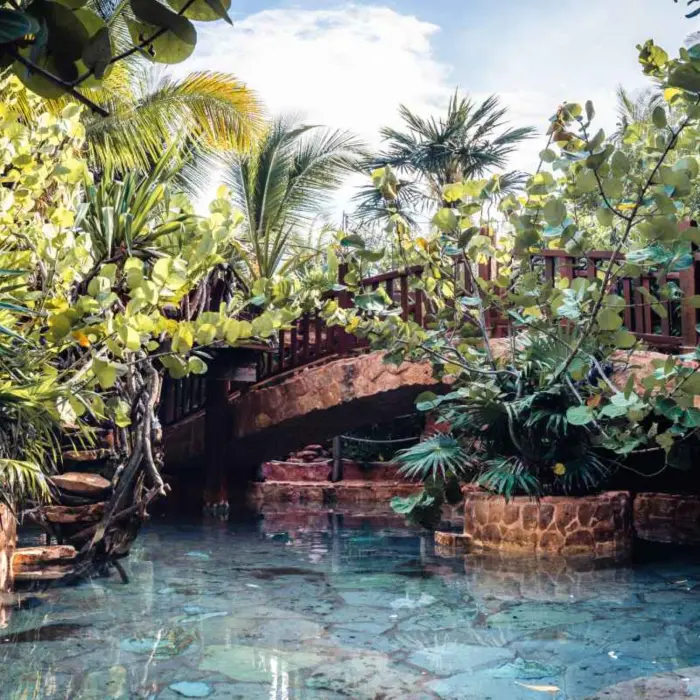 shallow water feature with bridge over it at Kanan Tulum Hotel & Spa