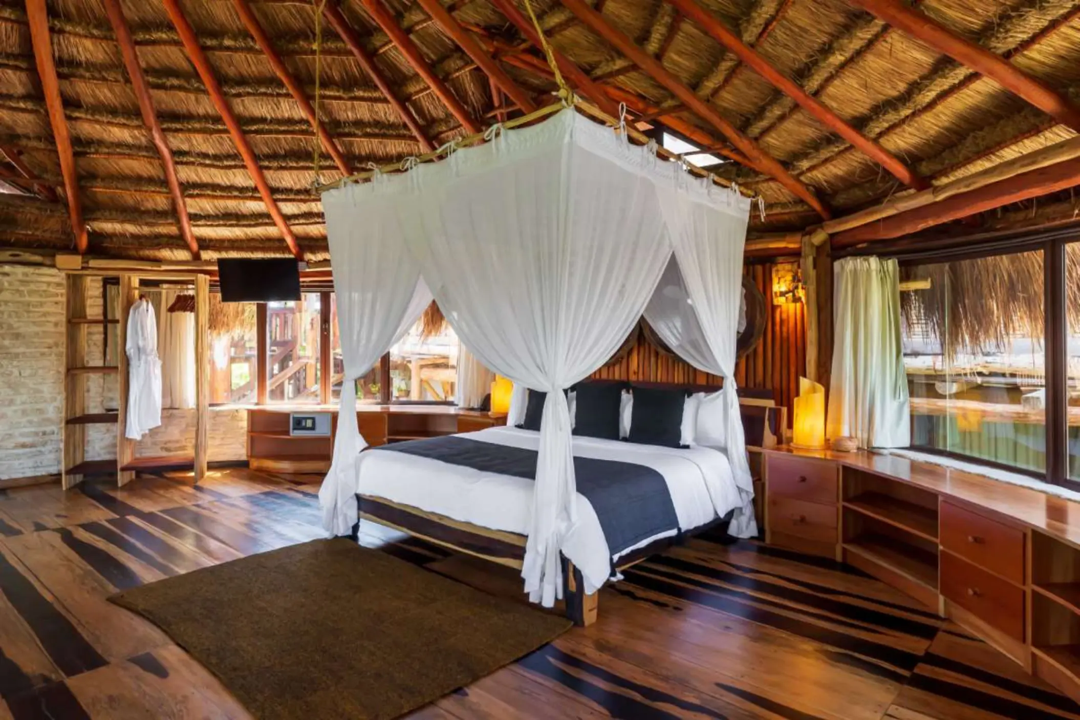 suite at Kanan Tulum Hotel & Spa with king bed and rustic wooden decor