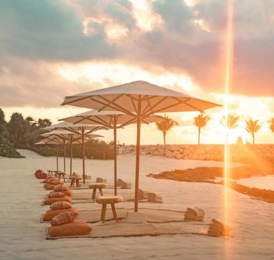 beach at La Casa de la Playa with beach umbrellas