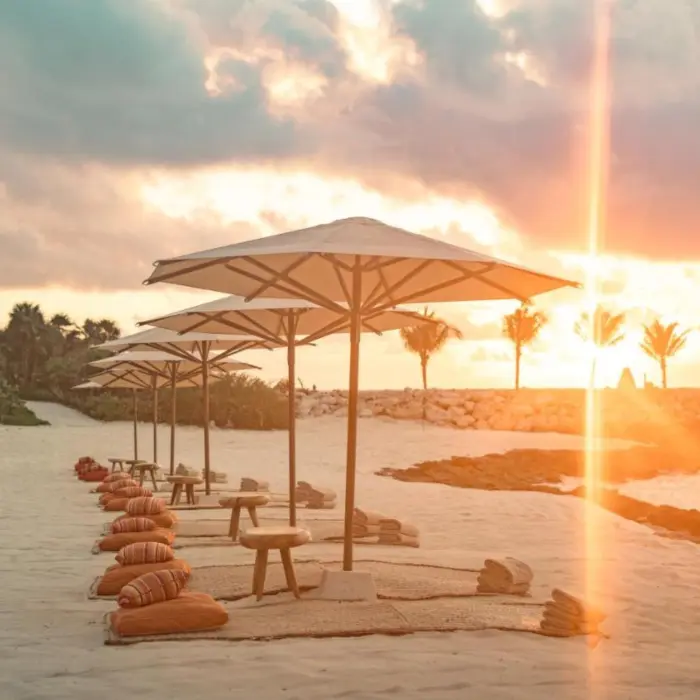 beach at La Casa de la Playa with beach umbrellas