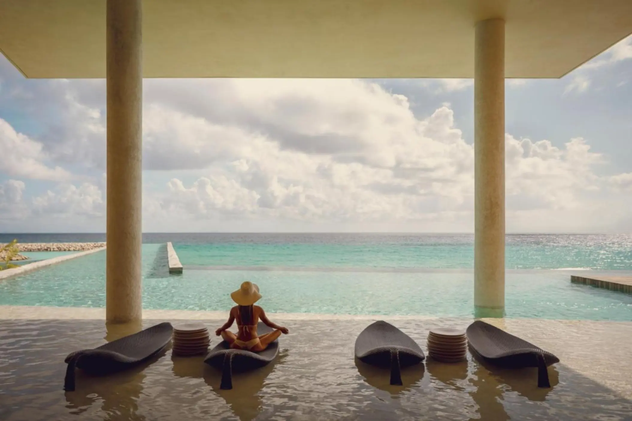 La Casa de la Playa pool with a lady sitting in it
