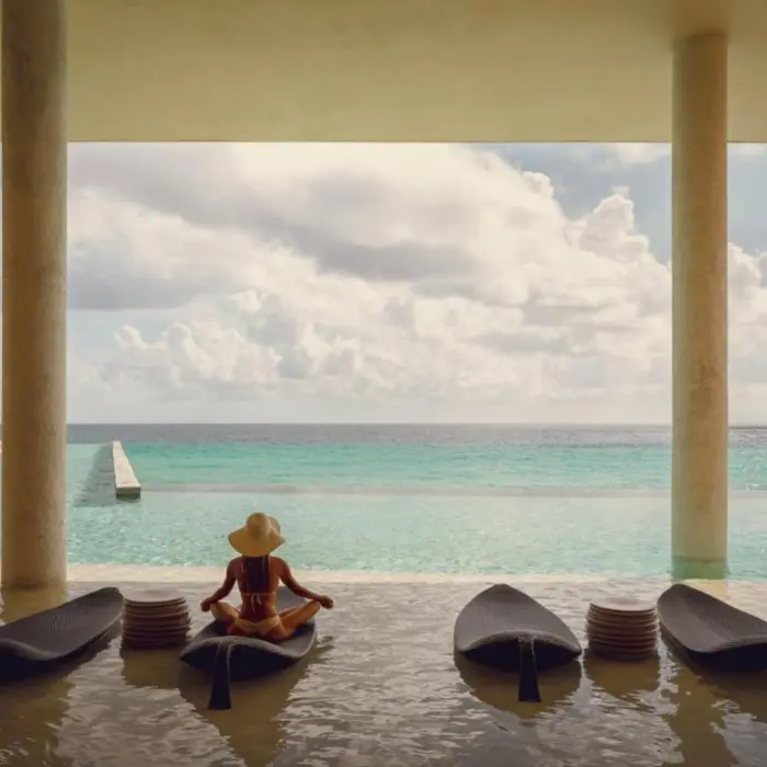 La Casa de la Playa pool with a lady sitting in it
