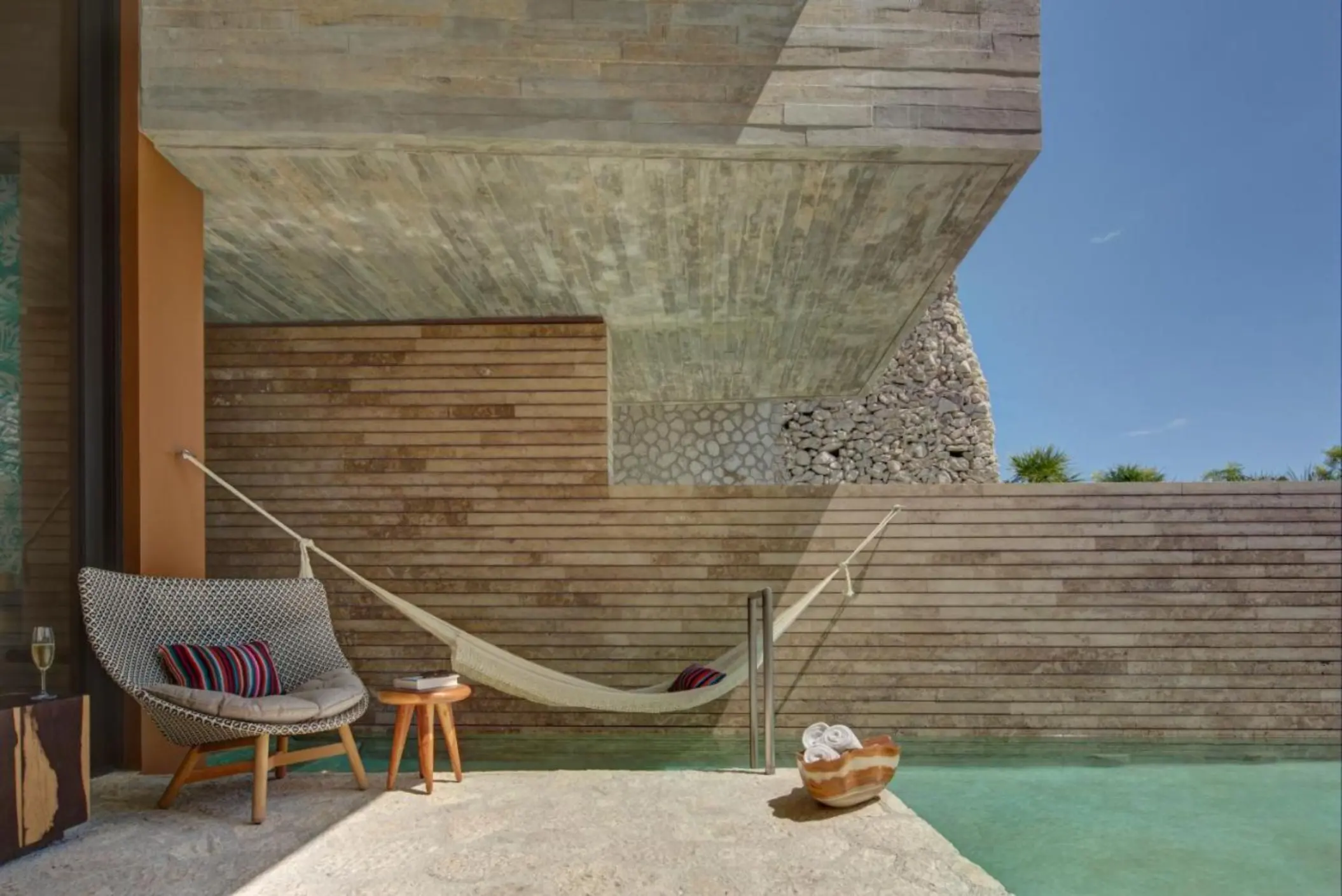 balcony of a suite with plunge pool, hammock, and seating at La Casa de la Playa