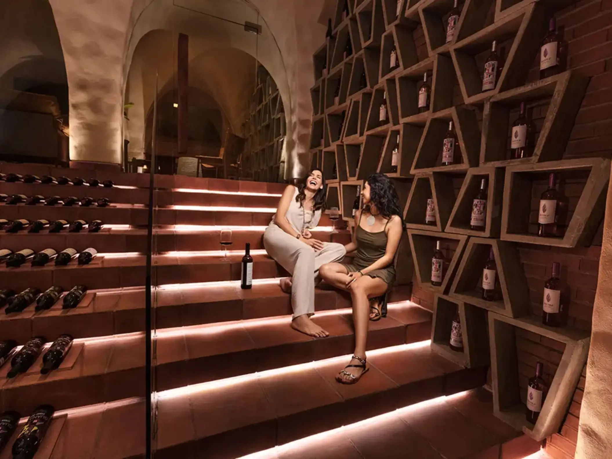 wine cellar at La Casa de la Playa with 2 women sitting and chatting