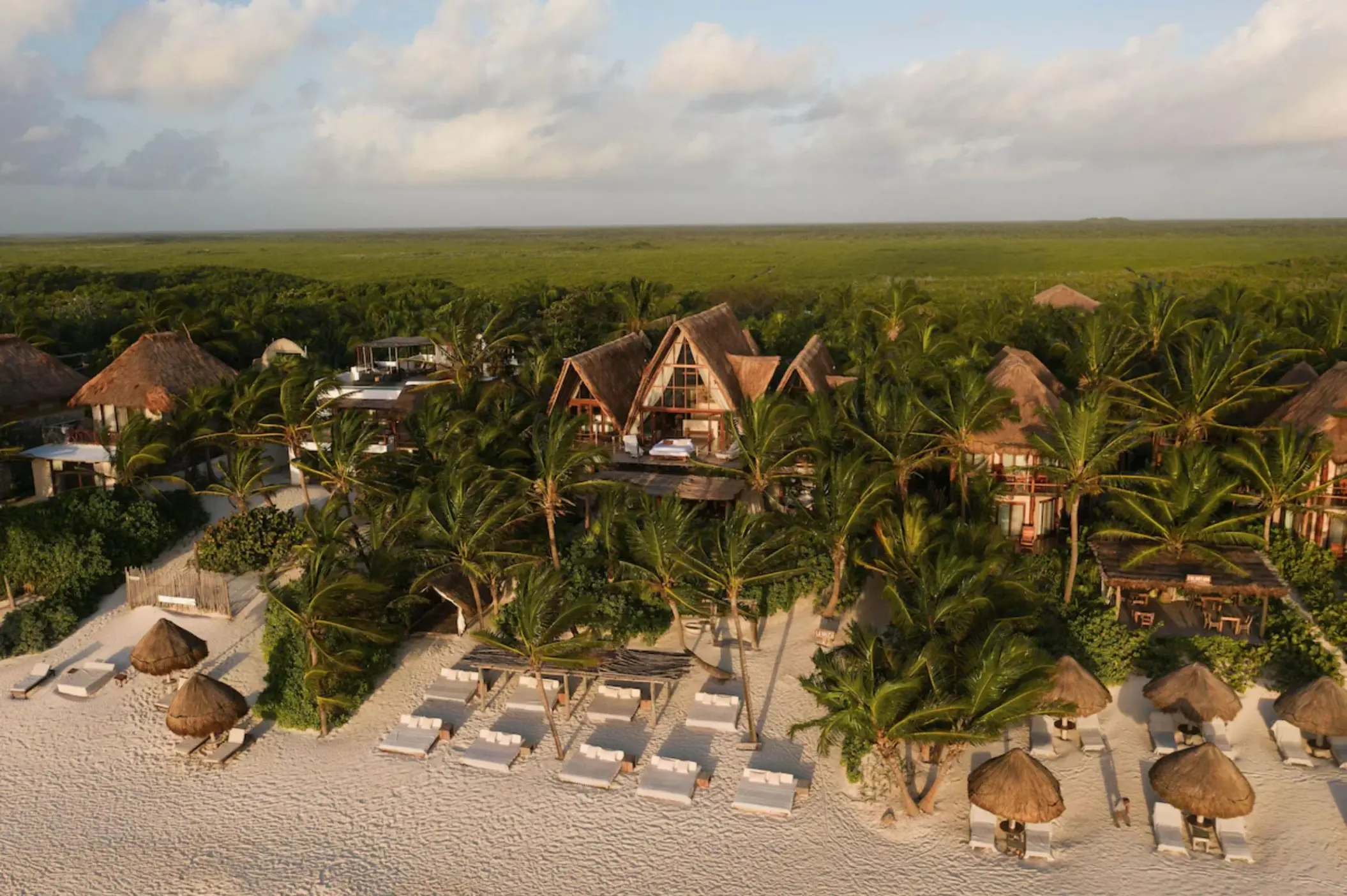 aerial view of La Valise Tulum with the beach and buildings and palms