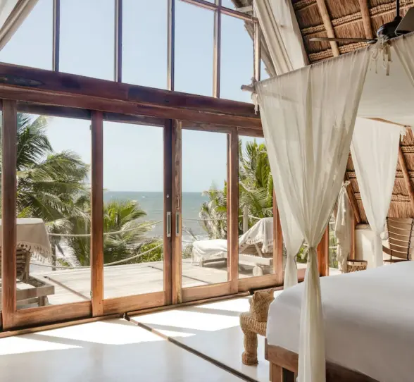 rustic room at La Valise Tulum with wooden accents and ocean views
