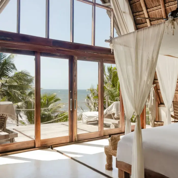 rustic room at La Valise Tulum with wooden accents and ocean views