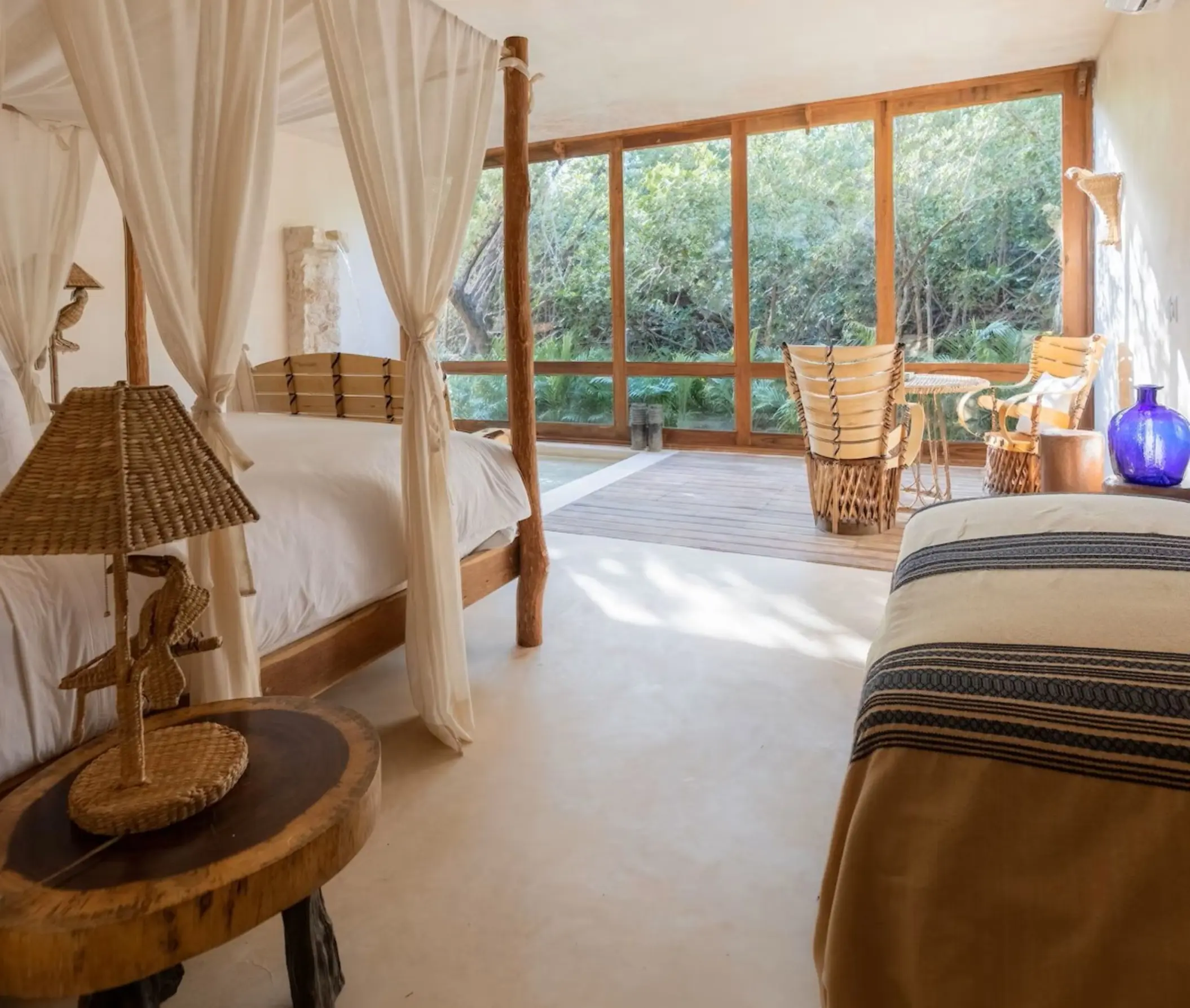 suite at La Valise Tulum with cane and wood accents and forest views