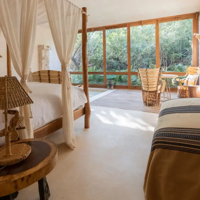 suite at La Valise Tulum with cane and wood accents and forest views