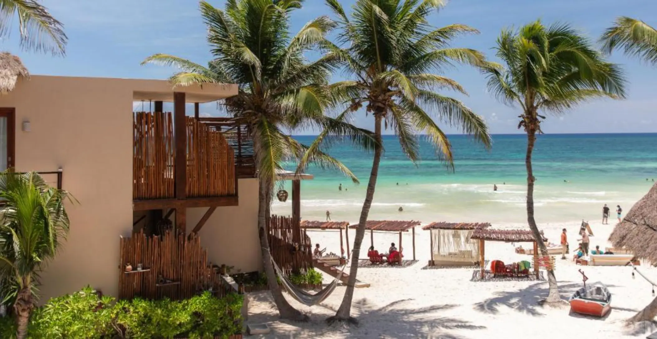 exteriors of La Zebra with beach cabanas and hammocks