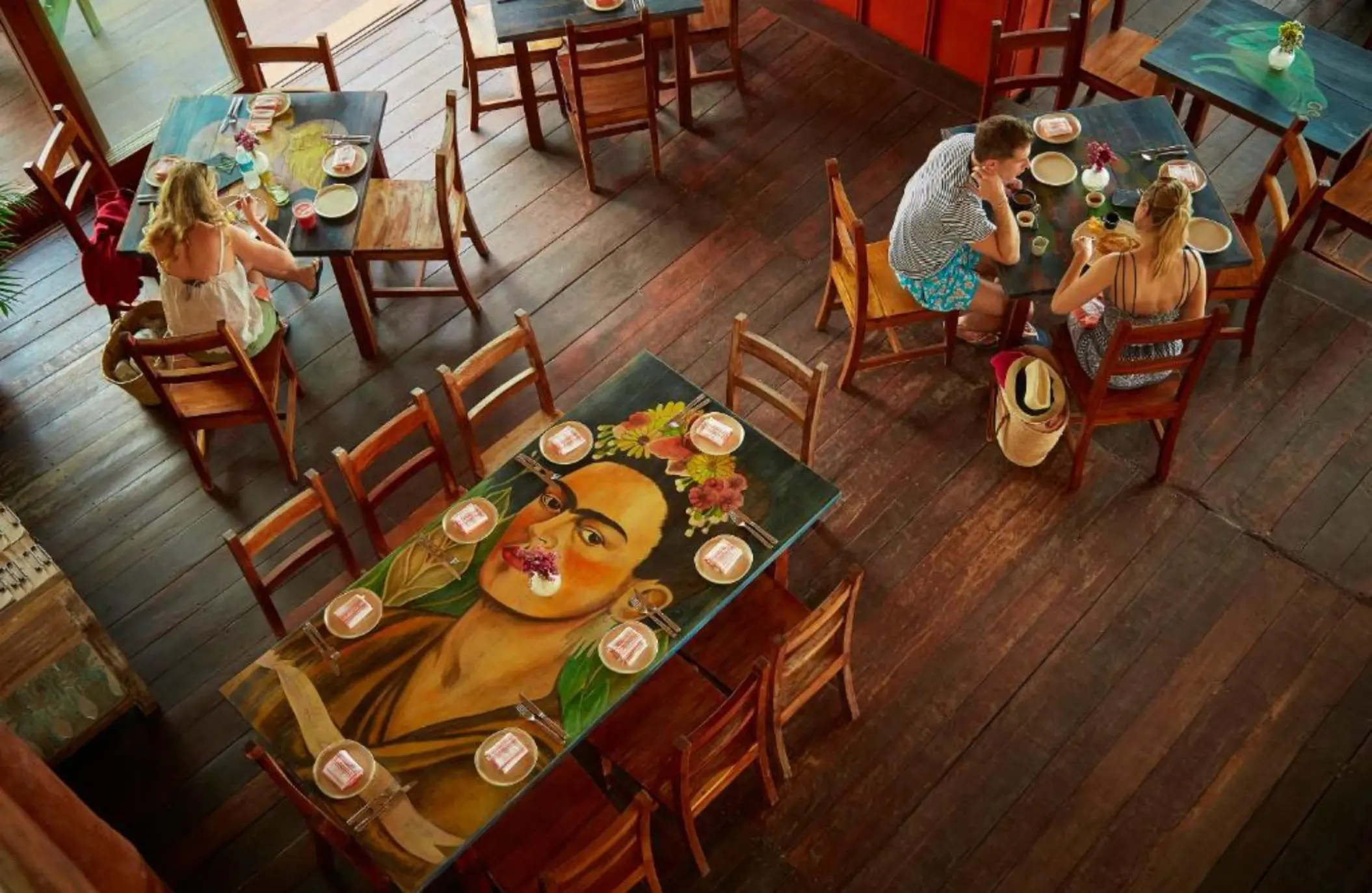 restaurant with vibrant art at La Zebra Tulum