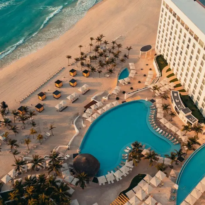 top view of Le Blanc Spa Resort Cancun with its pools and beach and buildings