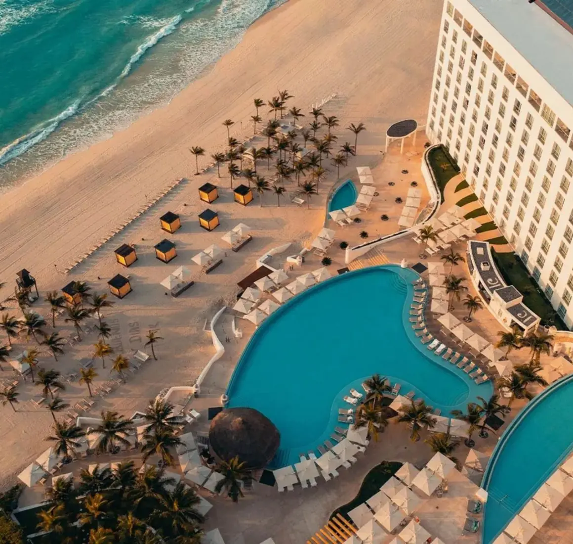 top view of Le Blanc Spa Resort Cancun with its pools and beach and buildings