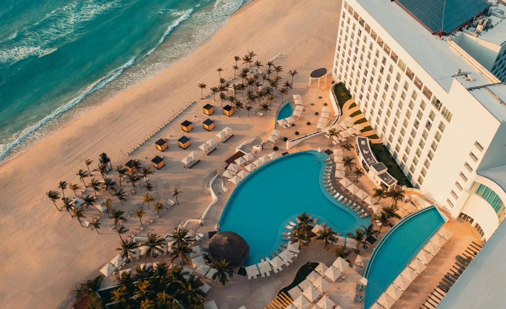 top view of Le Blanc Spa Resort Cancun with its pools and beach and buildings