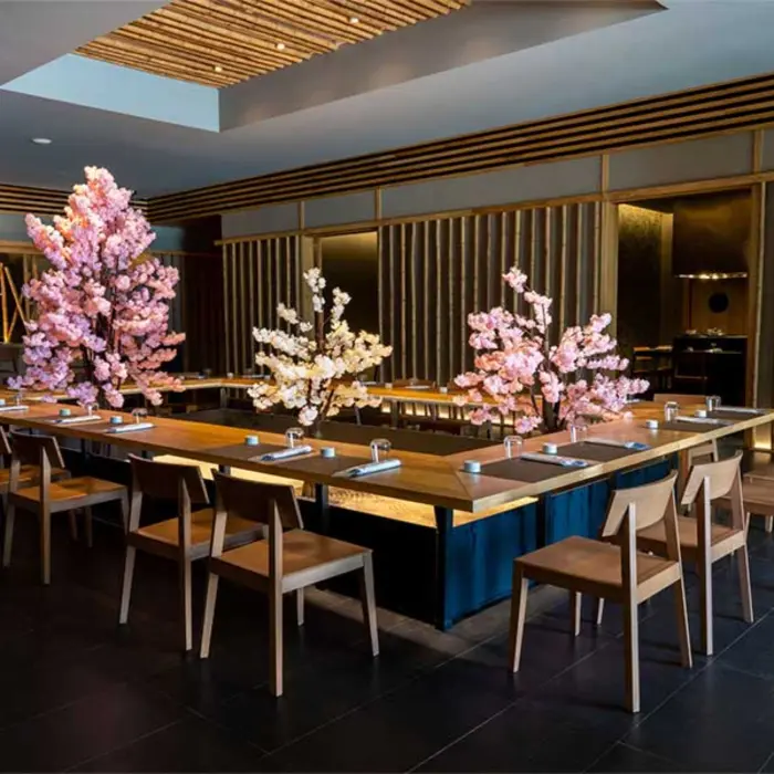 Elegant dining space with cherry blossom decor, wooden furniture, and a zen-inspired ambiance.