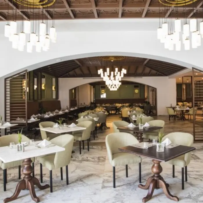 Bright and spacious buffet restaurant with elegant chandeliers, marble floors, and cozy dining areas.