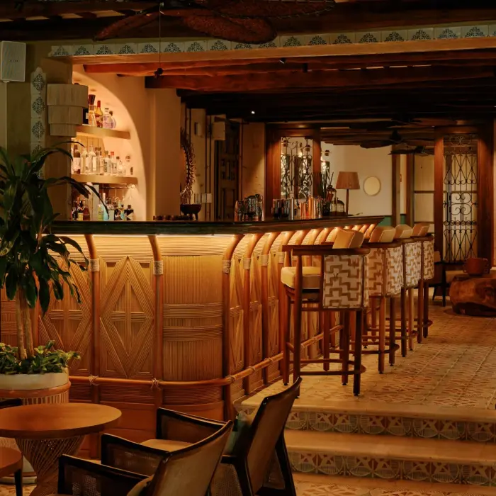cozy Bambuco restaurant bar at Maroma Belmond featuring wooden tables and chairs