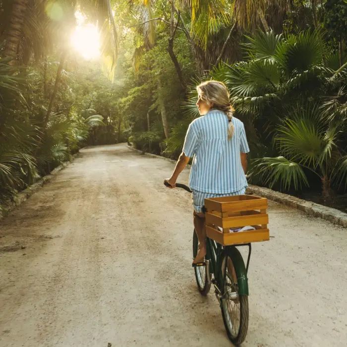 girl riding bike inside Maroma a Belmond Hotel