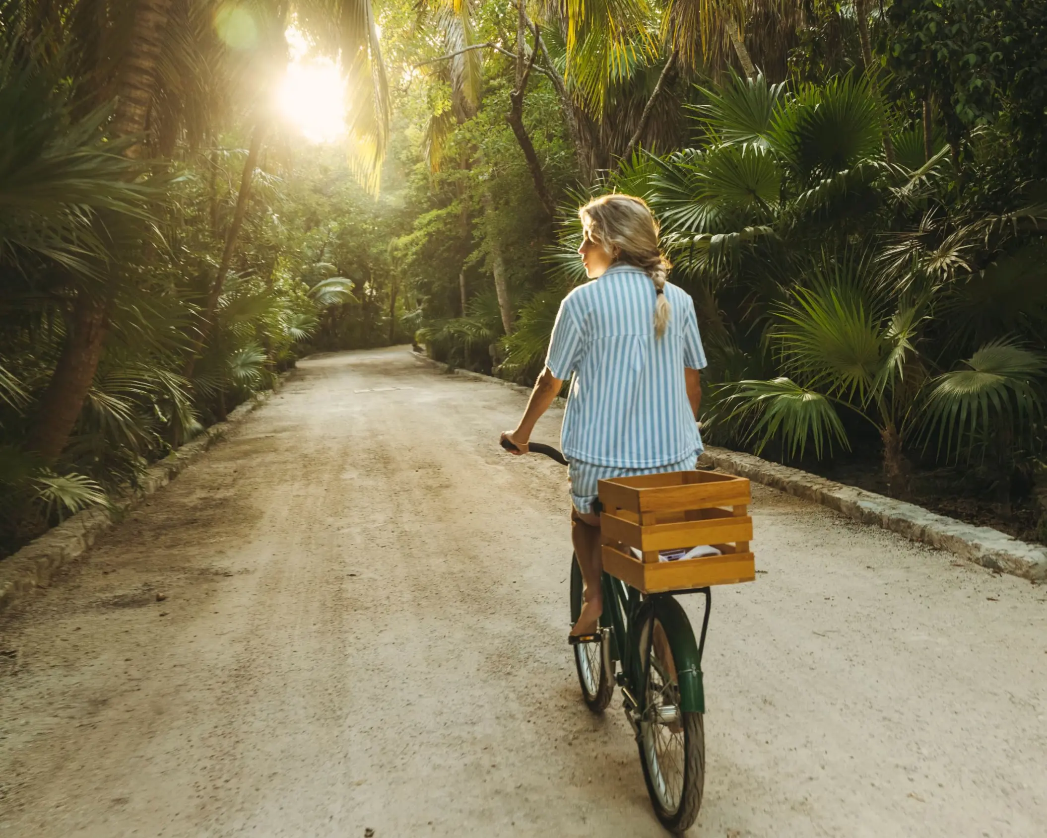 girl riding bike inside Maroma a Belmond Hotel