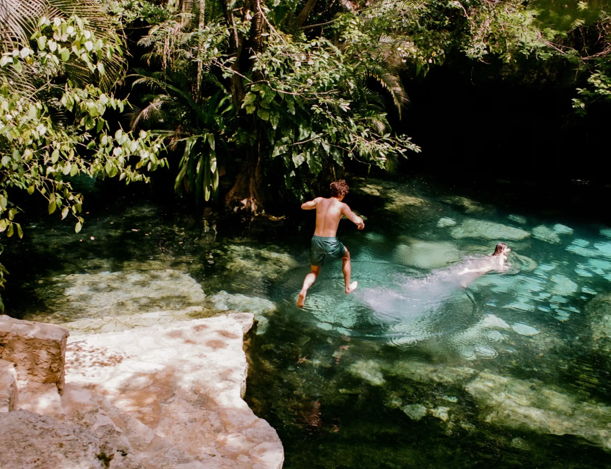 kids jumping in a cenote at Maroma a Belmond Hotel