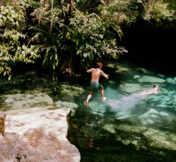 kids jumping in a cenote at Maroma a Belmond Hotel