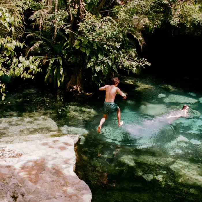 kids jumping in a cenote at Maroma a Belmond Hotel