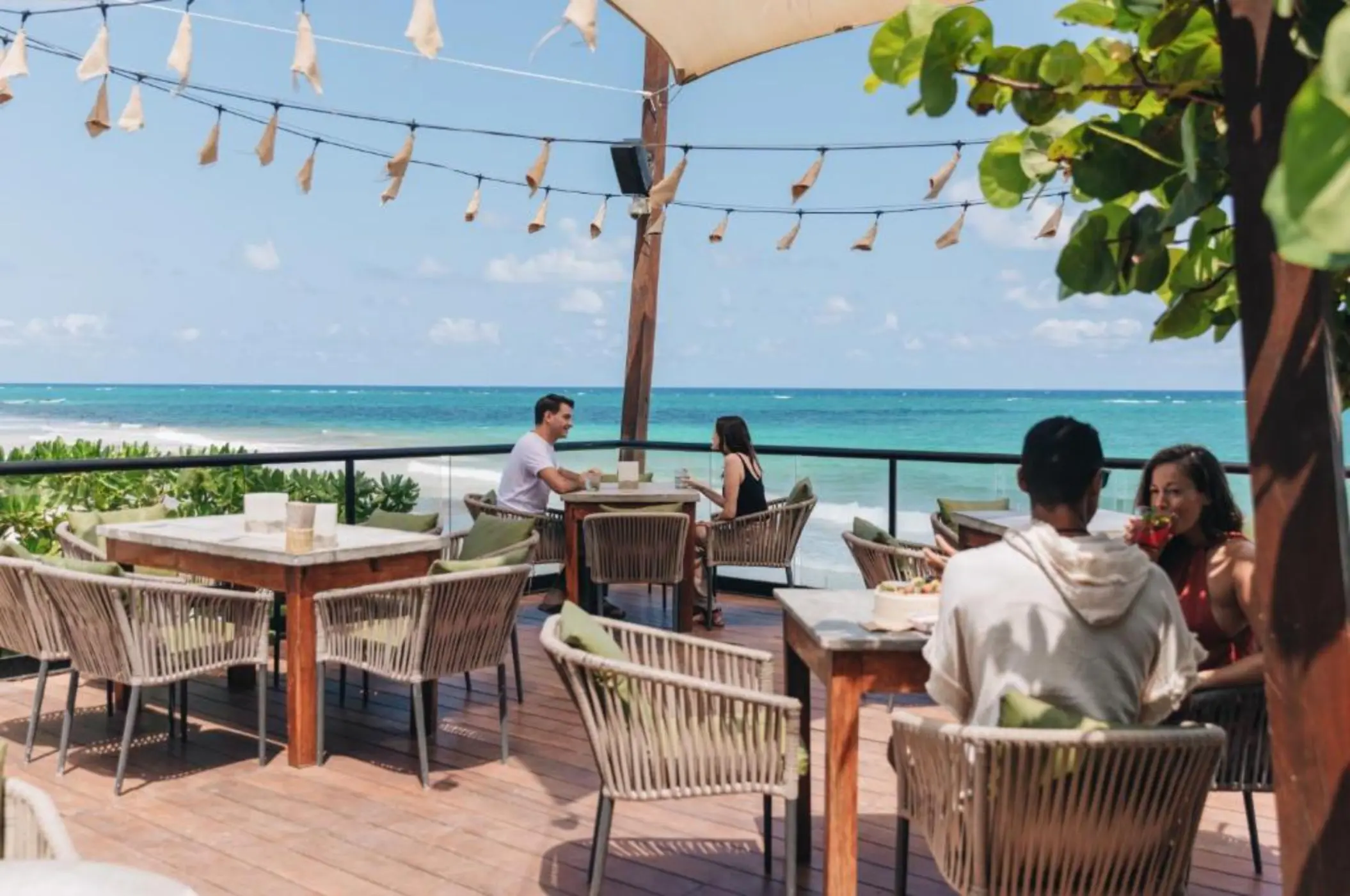 people at the seafront restaurant at Mezzanine Hotel