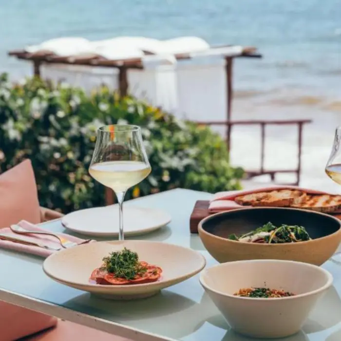 a seafront table setup with food at Mi Amor